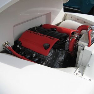 Engine bay of a pickup truck, throbbing Corvette engine.