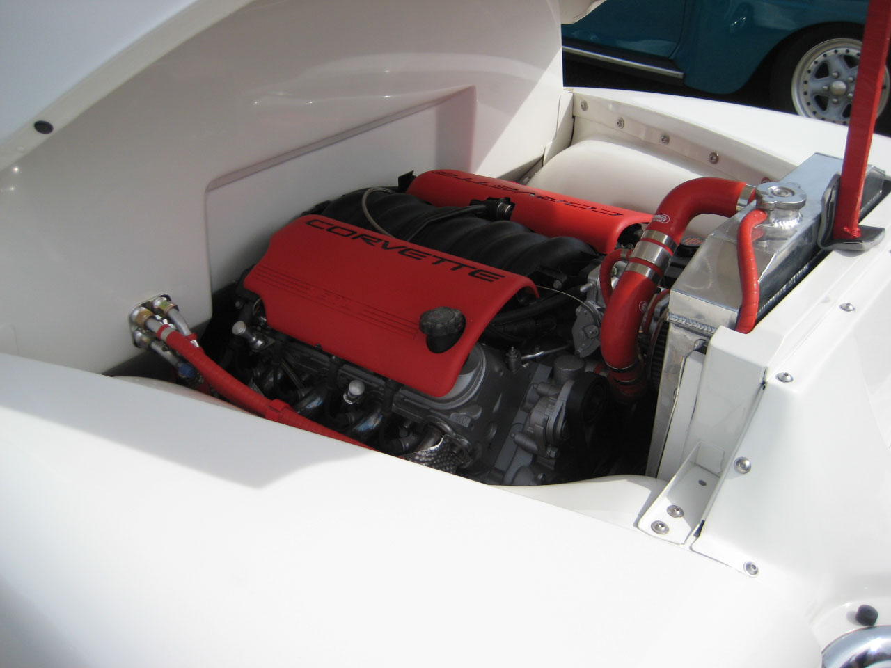 Engine bay of a pickup truck, throbbing Corvette engine.